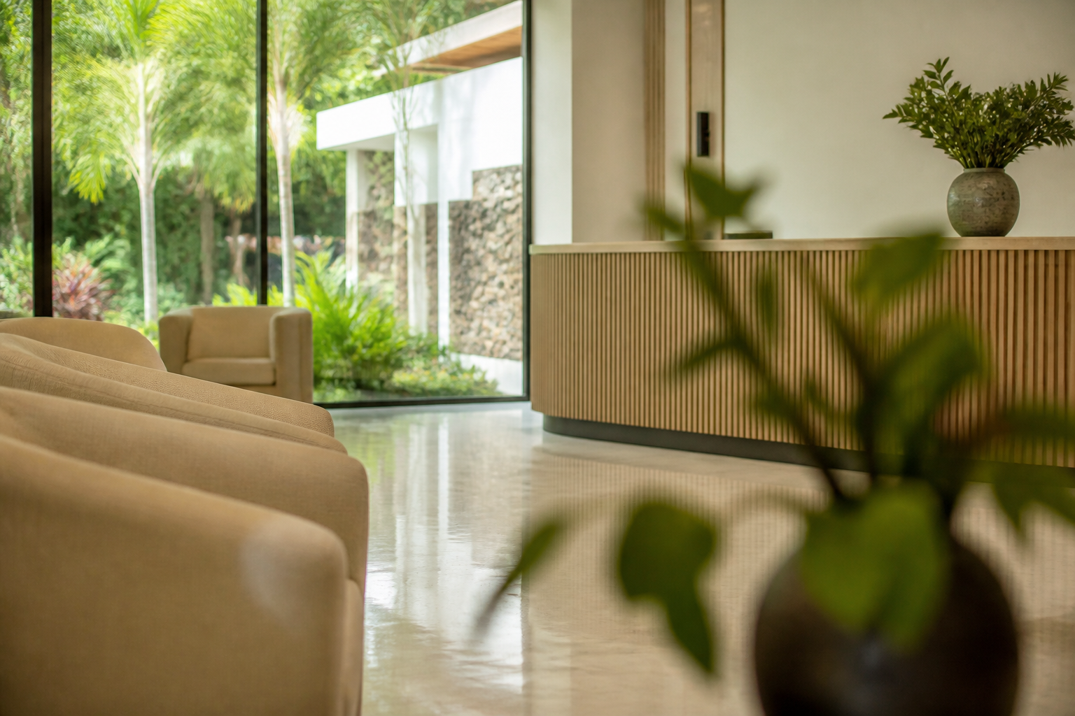 clean, modern reception area of a Mauritius private clinic, tropical garden visible through large windows, soft natural light, no people visible